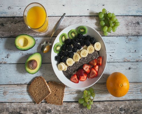 Colorful table with fresh fruits, vegetables, and seeds